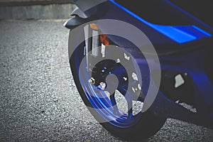 Close up blue motorcycle front tire.
