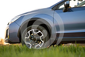 Close up of blue off road car on green grass. Traveling by auto, adventure in wildlife, expedition or extreme travel on a SUV