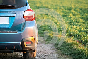 Close up of blue off road car wheel on gravel road. Traveling by auto, adventure in wildlife, expedition or extreme travel on a