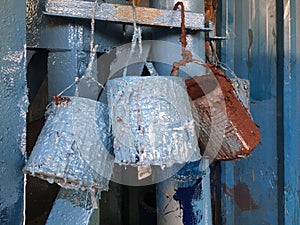 Close up Blue Paint bucket hanging on wall  charni road mumbai