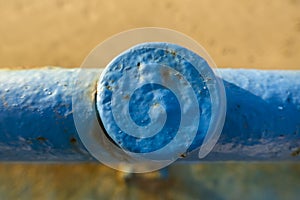 Close-Up of Blue Painted Metal Post with Weathered Texture