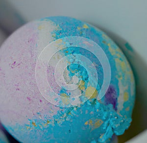 Close up of blue and pink bath bomb on white background