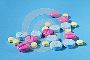 Pharmaceutical pills, tablets, medication on blue background