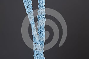 Close up of blue raffia cord on grey background