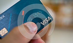 Close up blue visa card with blurry background