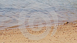 Close-up of blue water with calm ripples.Clear water of sea waves on the beautiful beach.