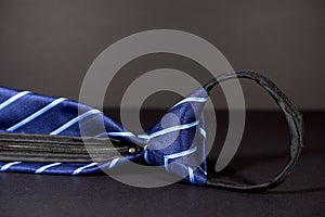 a close up of a blue and white striped tie with black zipper