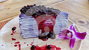 Close up of blueberry cheesecake on wood table