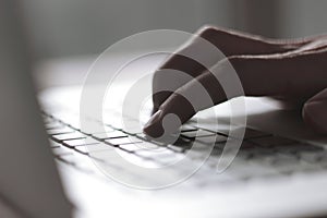 Close up. blurred image of male hand typing on laptop keyboard photo
