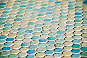 Close up of blurred round colorful tiles - yellow, tourquise and blue