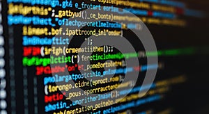Close-up blurred view of colorful computer code on a dark screen programming and technology concept