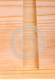 Close-up of a board with a woodworking dado groove isolated vert