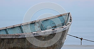 Close-up of the boat of the fisherman in front of the calm blue sea waves