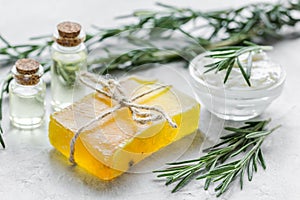 Close up body care rosemary cosmetic products on stone background