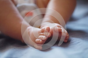 Close-up body parts baby infant chubby feet foot black isolated background cute baby boy toes innocent pure happy smile