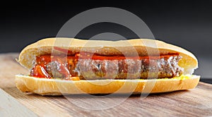 close up of boerewors roll on wooden board