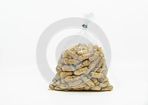 Close up of boiled peanuts in a cleared plastic bag for sale in the market, ready to eat, solated image on white background, front