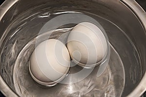 Close up boiling eggs in pot