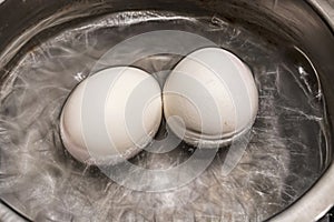 Close up boiling eggs in pot