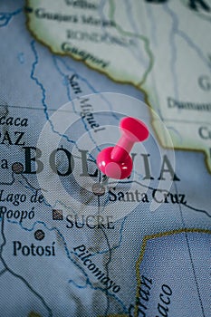 Close up of Bolivia pin pointed on the world map with a pink pushpin