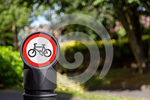 a close up of a bollard with a no cycling sign next to a cycle path