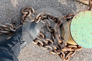 Close-up of bollards and iron chains on an old River barge. Securing the ship with a large chain. Old rusty vintage mooring