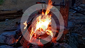 Close-up. Bonfire in the forest of neatly stacked chopped logs. SlowMo shooting