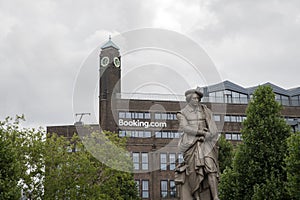 Close Up Booking.com Building At The Background With Rembrandt Statue At Amsterdam The Netherlands 25-7-2022