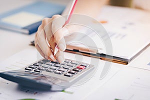 Close up of bookkeeper or financial inspector hands making report, calculating or checking balance.Investment, economy, saving mo