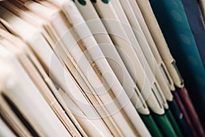 Close-up books. Thin children's books stand on the shelf together.