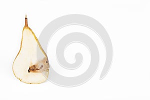 Close up Boring trace of a codling moth Cydia Pomonella, in a half middle wormy pear. On white background. photo