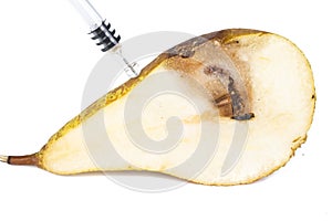 Close up Boring trace of a codling moth Cydia Pomonella, in a half middle wormy pear. On white background. With syringe. Concept n photo