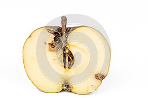 Close up Boring trace of a codling moth Cydia Pomonella, in a half wormy apple. On white background.