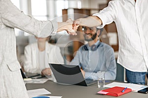 Close up of boss leader shaking hand of new team member recruiting him for job on staff briefin