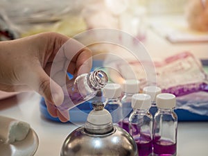 Close-up of bottle being sterilized with an alcohol burner before use in bacterial cultures. Medicine and microbiology concept