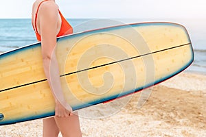 Close-up bottom body young adult slim sporty female surfer girl enjoy having fun swimming surfboard ocean coast wave