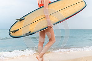 Close-up bottom body young adult slim sporty female surfer girl enjoy having fun swimming surfboard ocean coast wave