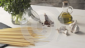 Close-up from bottom to top of the typical italian recipe spaghetti aglio olio e peperoncino garlic, oil and hot pepper