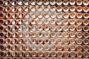 Bottoms of brown beer bottles group patterns texture on wall abstract for background photo