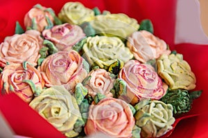 Close up bouquet of sweet sugarlles marshmallow rose flowers on white isolated beige background