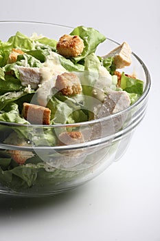 Close up of a bowl of Cesar Salad with white background