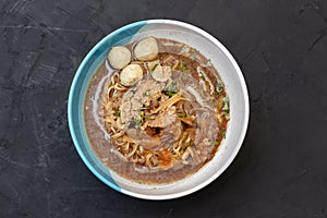 Close up of a bowl of Chinese style beef noodle soup.top view