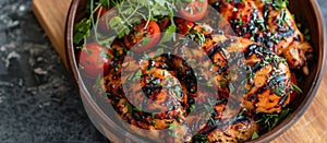 Close-Up of Bowl of Herbed BBQ Chicken With Tomatoes