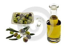 Close up of a bowl of olives and extra virgin olive oil in a glass cruet
