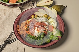 Close-up bowl poke with salmon, broccoli, carrots, pears and ptitim pasta. Seafood and vegetables. Healthy diet. Superfood