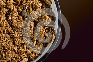 Close up of a bowl of red ancho chili pulled pork ready to use as a filling photo