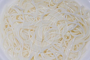 Close-up of a bowl of white and smooth rice noodles