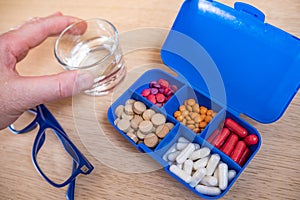 Close-up of a box for medical pills with a package of pills for daily medication with white, yellow drugs and capsules