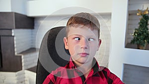 Close up of boy cross-eyed, young child looking goofy, funny with a silly