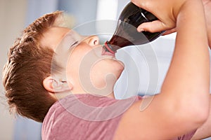 Close Up Of Boy Drinking Soda From Bottle